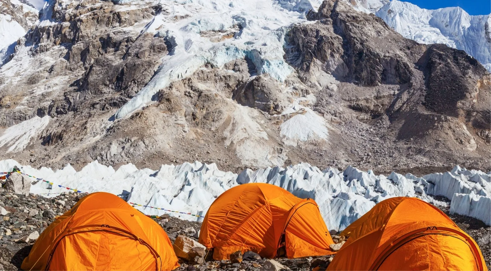 Orange tents at Everest Base Camp with the Khumbu Icefall behind