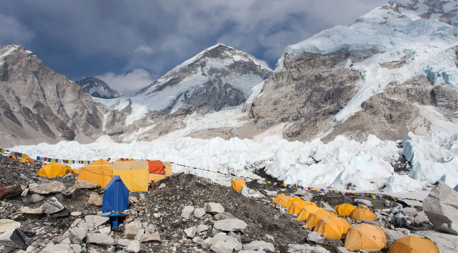 Everest Base Camp's tent city strung with prayer flags beneath the Khumbu Icefall