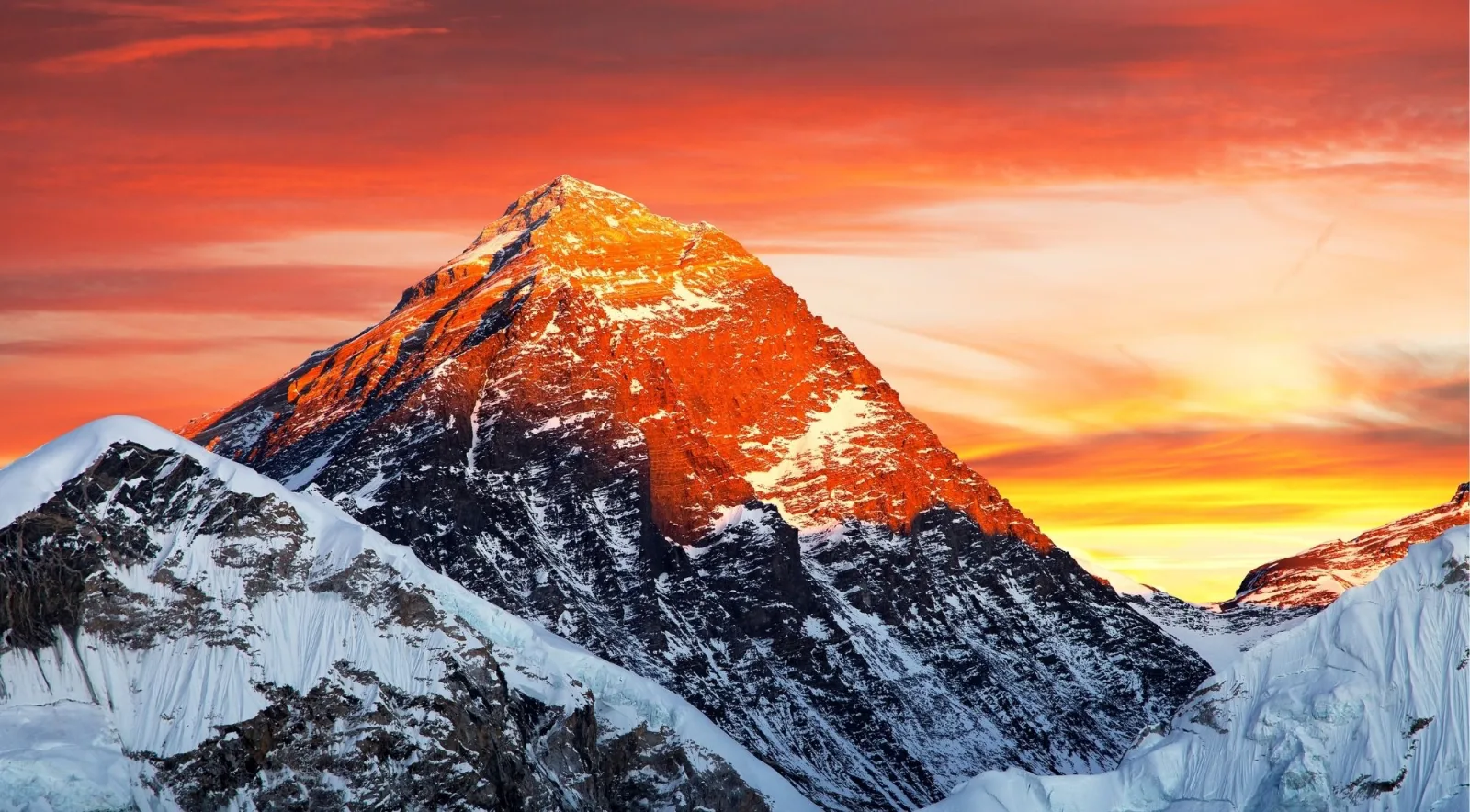 Mount Everest's summit glowing orange at sunset